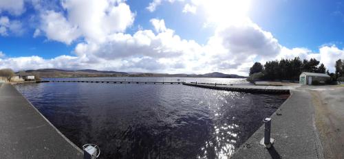 a large body of water with a dock at Donegal Thatched Cottage in Loughanure