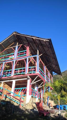 a building with a colorful staircase on the side of it at Casa de Campo La Prosperidad in Bobadilla