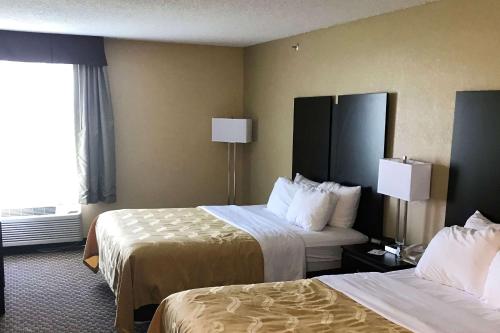a hotel room with two beds and a window at Quality Inn & Suites Mendota near I-39 in Mendota
