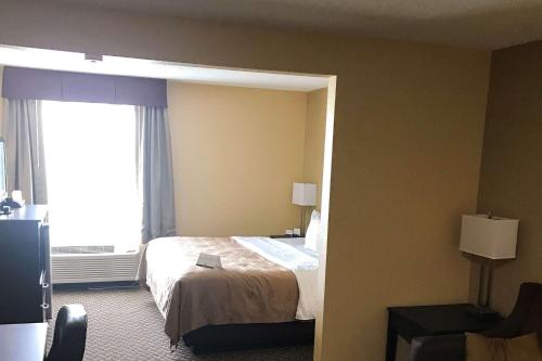 a hotel room with a bed and a window at Quality Inn & Suites Mendota near I-39 in Mendota