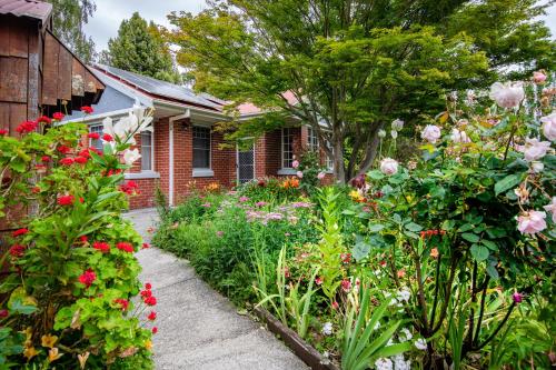 a garden of flowers in front of a house at Alexandria Bed and Breakfast in Wynyard