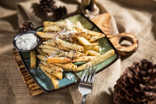 a plate of french fries on a table with a fork at Taipei 101 SPARKLE Hotel in Taipei