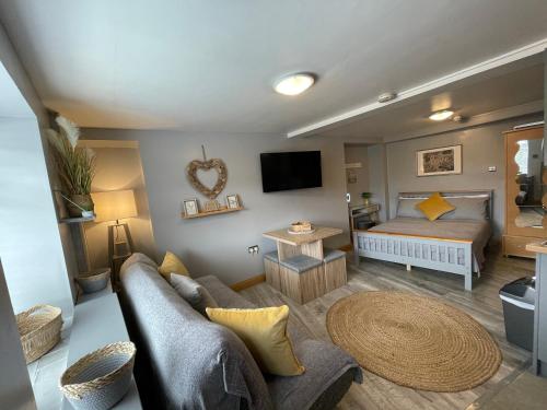 a living room with a bed and a couch at Westend Holiday Let 1 Brecon in Brecon