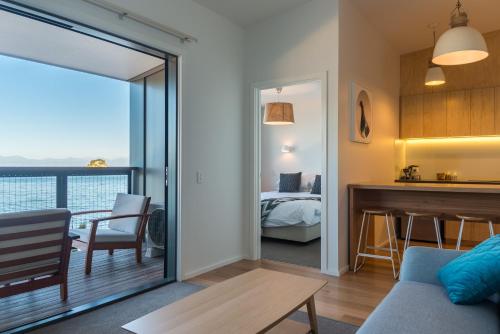 a living room with a view of a bedroom at Kaiteriteri Reserve Apartments in Kaiteriteri