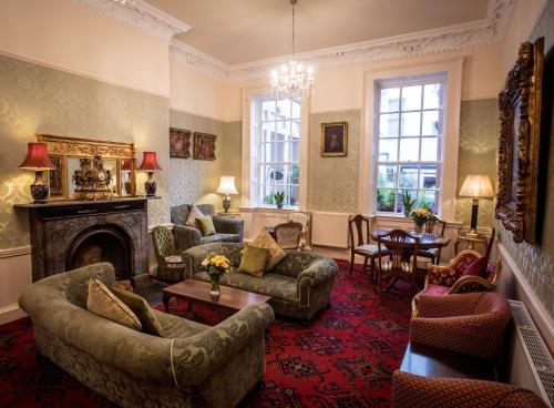 a living room with couches and a fireplace at Castle Hotel in Dublin