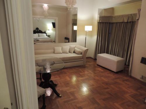 a living room with a couch and a bed at GM Rooms Boutique Hotel in La Rioja