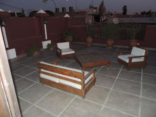 a patio with two chairs and a table and chairs at GM Rooms Boutique Hotel in La Rioja