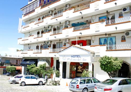 two cars parked in front of a large building at Paloma del Mar in Puerto Vallarta