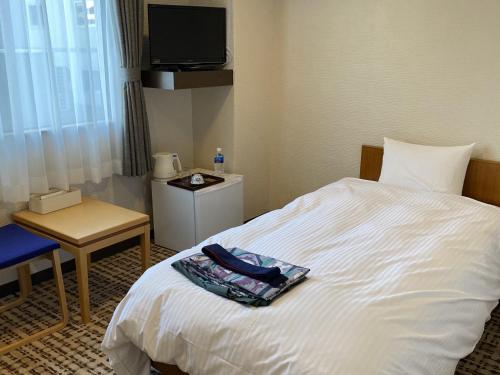 a hotel room with a bed and a television at Kiki Shiretoko Natural Resort in Shari