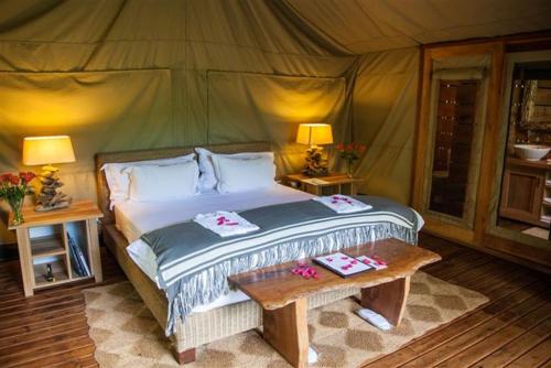 a bedroom with a bed in a tent at Summerfields Rose Retreat and Spa in Hazyview