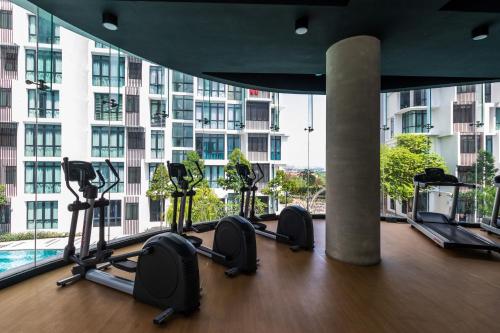 a gym with treadmills and ellipticals in a building at H20 Residence Ara Damansara by Airhost in Petaling Jaya