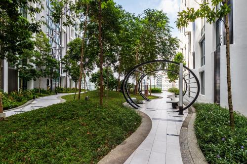 a walkway with a metal arch in a park at H20 Residence Ara Damansara by Airhost in Petaling Jaya