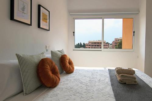 a bedroom with two chairs and a bed with a window at Phaedrus Living Cityview Luxury Flat Walnut Grove in Paphos