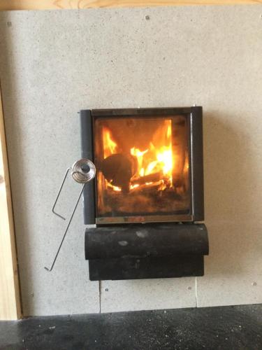 a brick oven with a fire in it at Chutor Grzegorza in Wysowa-Zdrój