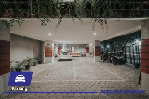 a garage with a car parked in a parking lot at DPARAGON KEMUNING in Yogyakarta