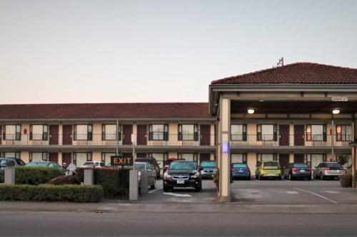 a parking lot in front of a building with cars parked at Sea Drift Inn in Eureka