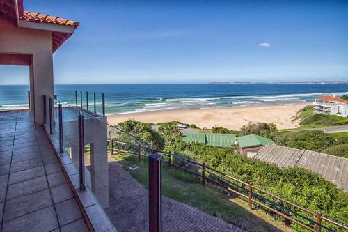 a balcony of a house with a view of a beach at Beach Music I and II in Keurboomstrand