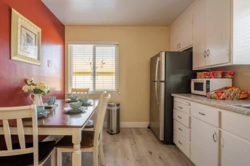 a kitchen with a table and a refrigerator at Luxury stay near Santana Row for vacation/business in San Jose
