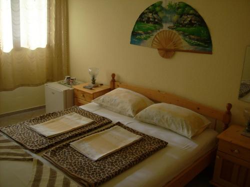 a bedroom with a bed with two trays on it at Hotel Pasians in Pomorie