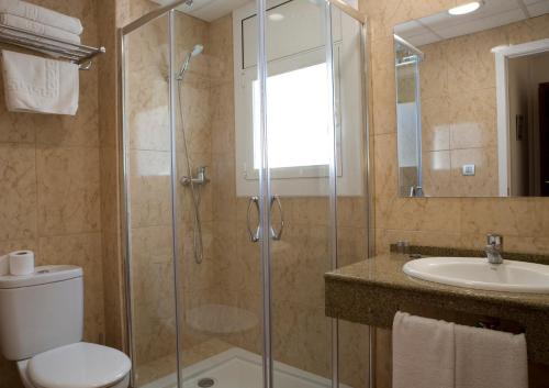 a bathroom with a shower, sink, and toilet at Hotel Tolosa in Salou