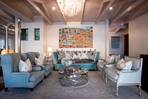 a living room with couches and a painting on the wall at Tintswalo Atlantic in Hout Bay