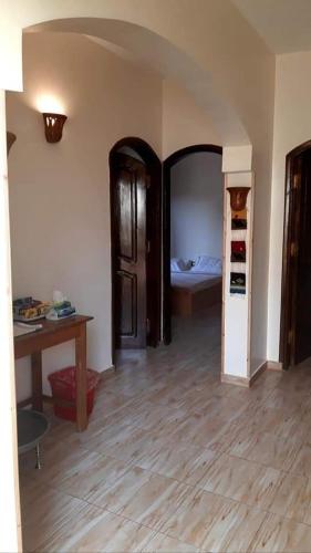 a room with a bedroom with a bed and a table at Habibi Nubian Guest House-Nubian Hospitality in Aswan