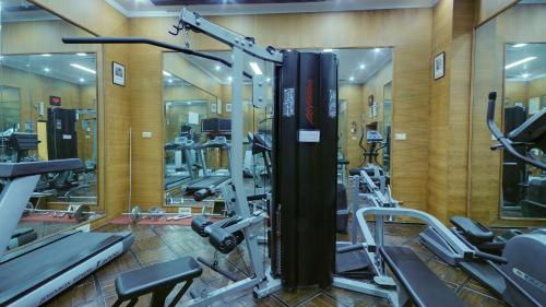 a gym with a bunch of treadmills and machines at Lemon Tree Premier “The Atrium” Ahmedabad in Ahmedabad