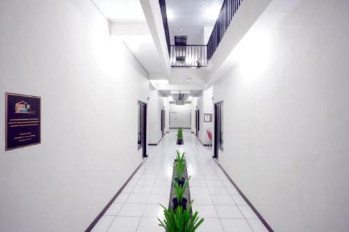 an empty hallway in a building with plants at DPARAGON IJEN NIRWANA in Malang