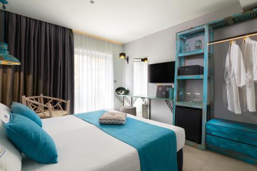 a hotel room with a bed and blue accents at Elakati Luxury Boutique Hotel - Adults Only in Rhodes Town