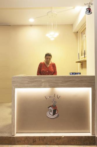 a person standing behind a counter in a room at Newest Deluxe BnB, Ranee BNB in Shillong