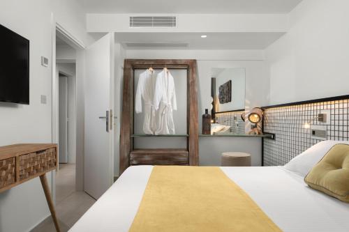 a bedroom with a bed and a bathroom at Elakati Luxury Boutique Hotel - Adults Only in Rhodes Town