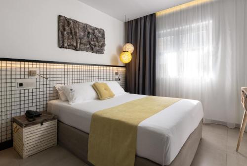 a bedroom with a large bed and a window at Elakati Luxury Boutique Hotel - Adults Only in Rhodes Town