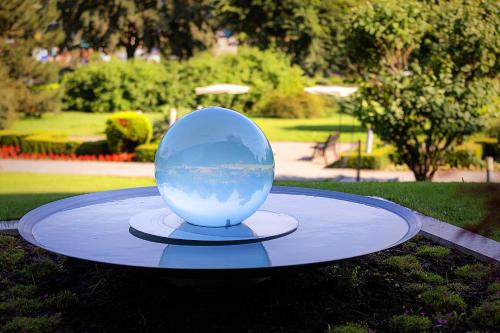 a large glass ball sitting on a table in a park at Ana Hotels Europa Eforie Nord in Eforie Nord