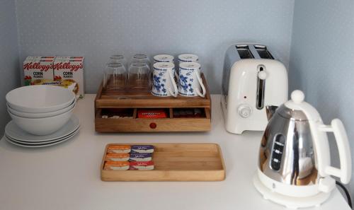 a kitchen counter with a counter top with a coffee maker at Moss Cottage in Bickley