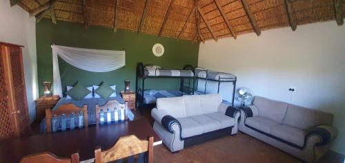 a living room with a couch and a bunk bed at Tava Lingwe Game Lodge & Wedding Venue in Parys