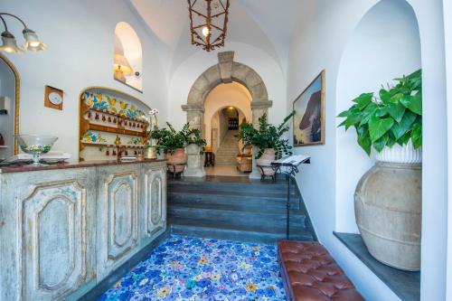 a room with a staircase with a large vase at Hotel Casa Albertina in Positano