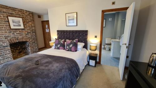 a bedroom with a bed and a dresser at Ty Morgan's in Rhayader