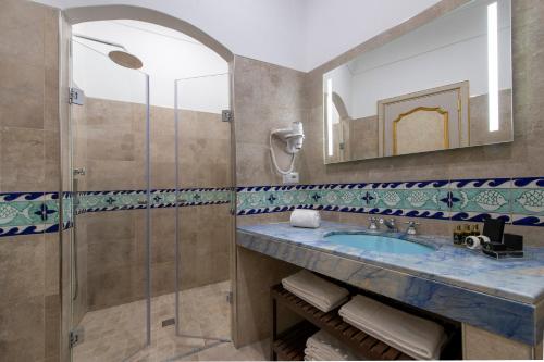 a bathroom with a sink and a bathtub at Hotel Casa Albertina in Positano