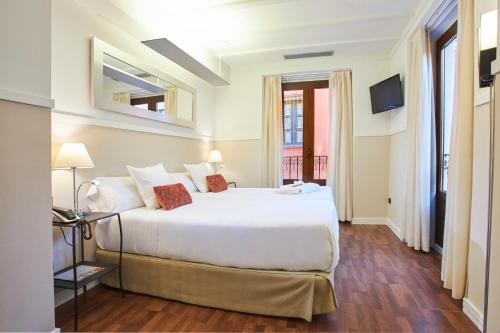Cama o camas de una habitación en U-Sense Sevilla Centro