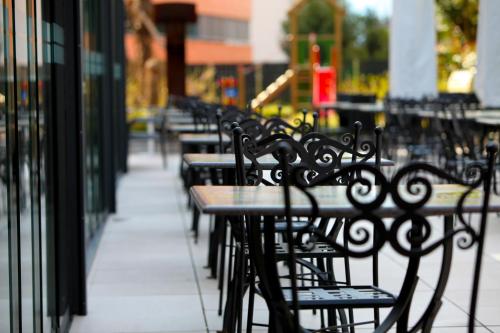 a row of tables and benches sitting outside a building at Hotel Bellavista Locarno in Locarno