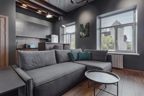 a living room with a couch and a table at Deribasovskaya 18 Loft in Odesa