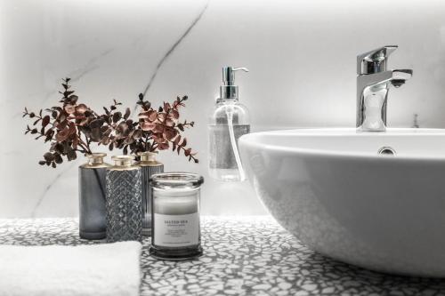 a bathroom with a sink and a counter top with a sinkktop at Romagna Suite Hotel in Gatteo a Mare