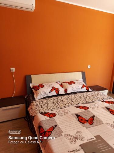 a bedroom with a bed with butterflies on it at La Botezatu in Tuzla