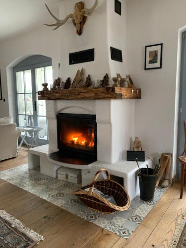 a fireplace in a living room with a fire place at Farm & Country House Gizewo 32 in Sorkwity