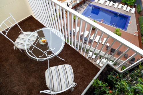 a balcony with a table and a chair and a pool at Wellington Hotel & Spa Madrid in Madrid