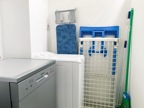 a small bathroom with a sink and a dishwasher at Le Cocon vous accueille avec plaisir ! in Fort-de-France