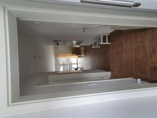 a kitchen with a large white tub in a room at Haus Taybeerweg in Aurich