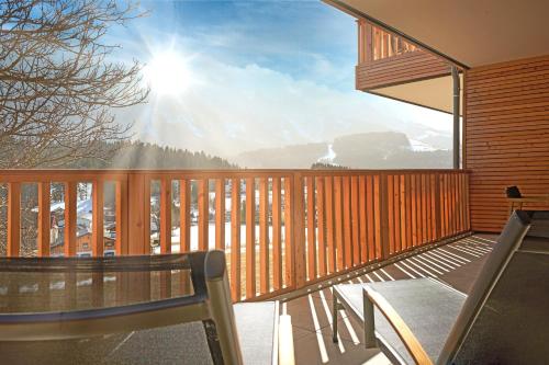 a balcony with a chair and a view of a mountain at Adler Lodge D1 by AA Holiday Homes in Tauplitz