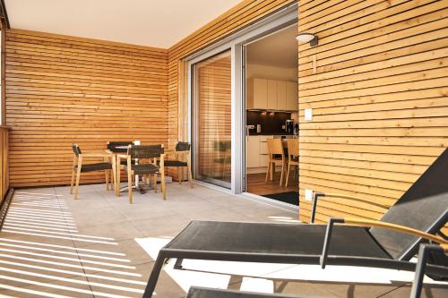 a patio with a table and chairs and a dining room at Adler Lodge D1 by AA Holiday Homes in Tauplitz