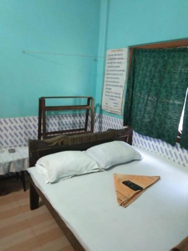a bed with a napkin on top of it at Vamoose Nirmala in Kailāshahar